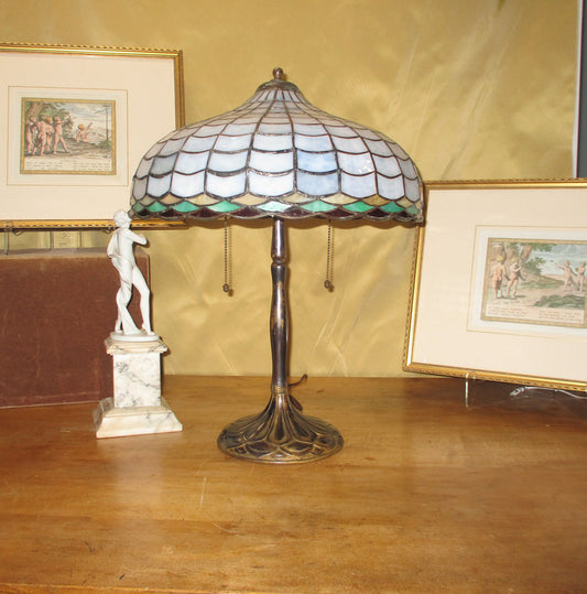 Leaded stained glass shade in cloud pattern on a brass stick base.