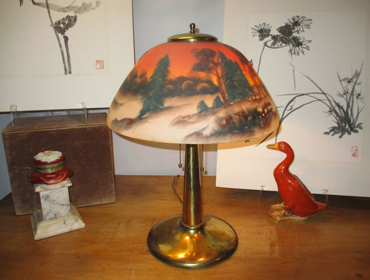 Arts and Crafts lamp with solid brass base and reverse painted shade.